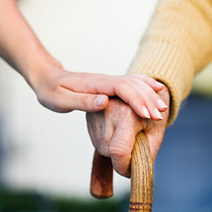 young hand touching old hand